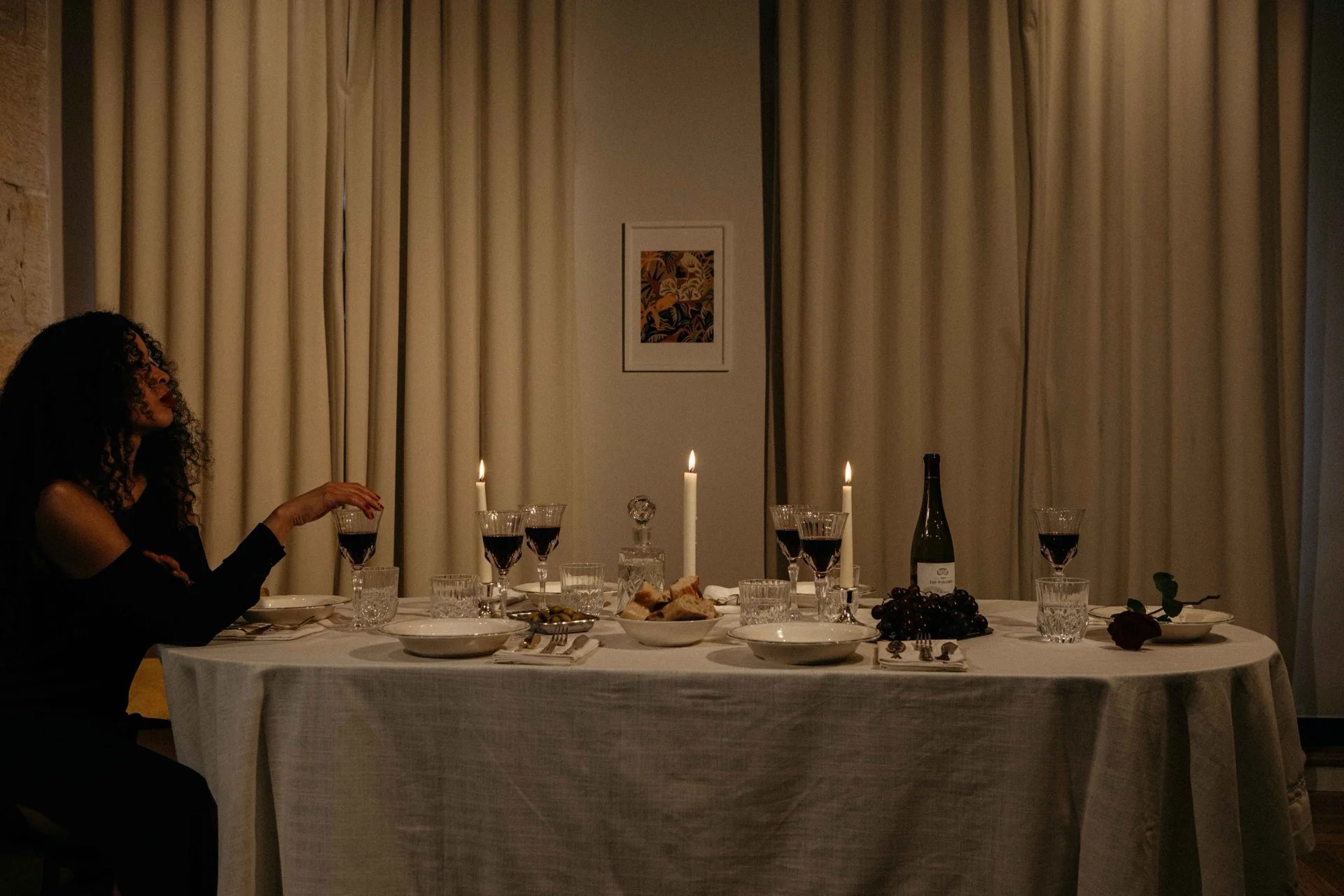 Guests in conversation over wine at a dinner table